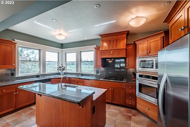 1603 Berkeley Ln, Monmouth, OR 97361 - kitchen featuring appliances with stainless steel finishes, a sink, brown cabinets, backsplash, and recessed lighting