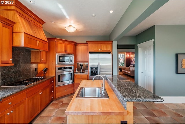 1603 Berkeley Ln, Monmouth, OR 97361 - kitchen with stainless steel appliances, a sink, a kitchen island with sink, tile countertops, and tasteful backsplash