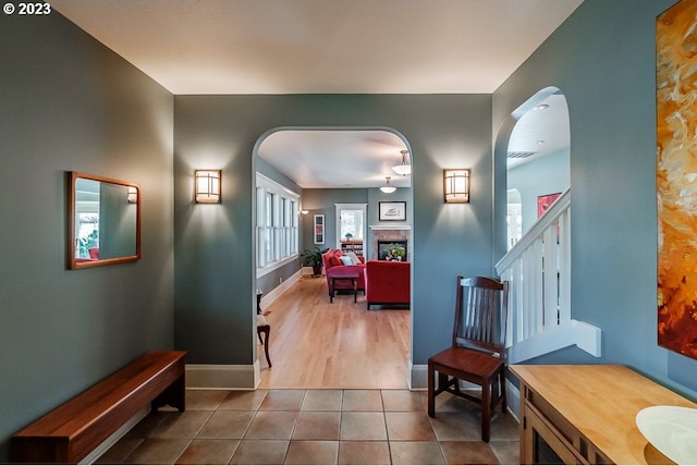 1603 Berkeley Ln, Monmouth, OR 97361 - hall featuring arched walkways, stairs, baseboards, and tile patterned flooring