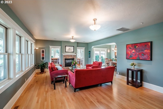 1603 Berkeley Ln, Monmouth, OR 97361 - living room with baseboards, light wood finished floors, arched walkways, and plenty of natural light