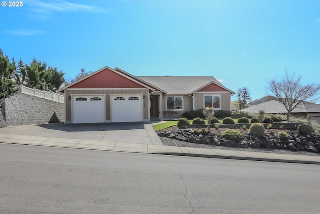 view of front of home featuring board and batten siding, fence, a garage, and driveway