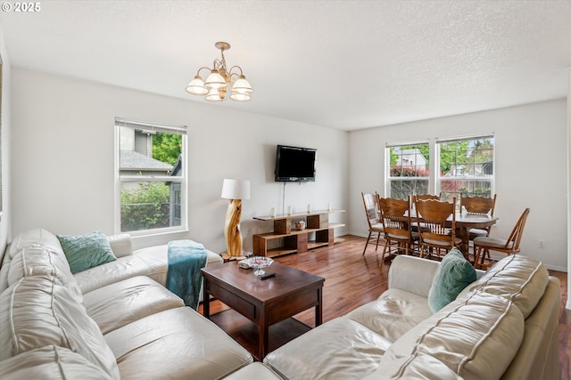 19030 SW Pike Ln, Beaverton, OR 97078 - living area featuring wood finished floors, a chandelier, and a textured ceiling