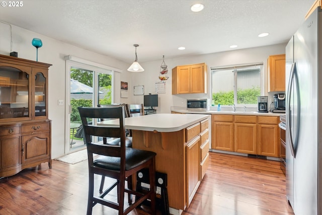 19030 SW Pike Ln, Beaverton, OR 97078 - kitchen with appliances with stainless steel finishes, healthy amount of natural light, a breakfast bar, light countertops, and recessed lighting