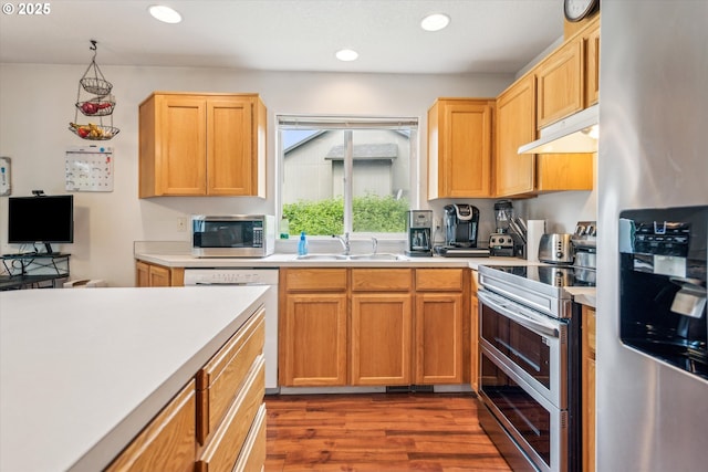 19030 SW Pike Ln, Beaverton, OR 97078 - kitchen featuring stainless steel appliances, under cabinet range hood, a sink, light countertops, and recessed lighting