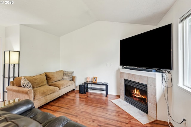 19030 SW Pike Ln, Beaverton, OR 97078 - living area with lofted ceiling, a tile fireplace, and light wood-type flooring