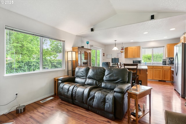 19030 SW Pike Ln, Beaverton, OR 97078 - living room with plenty of natural light, light wood-style floors, vaulted ceiling, baseboards, and recessed lighting