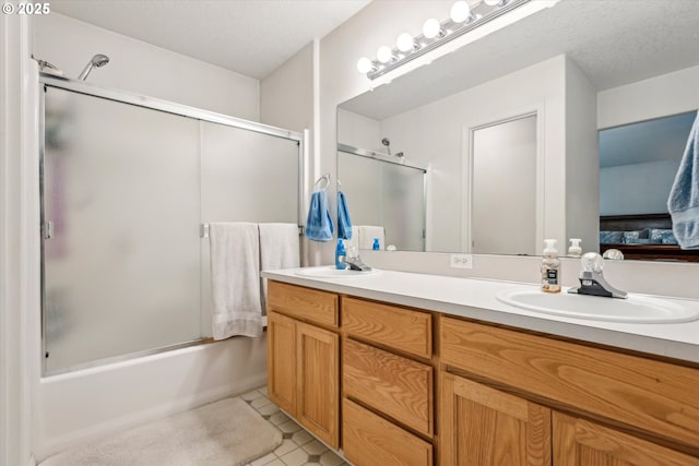 19030 SW Pike Ln, Beaverton, OR 97078 - ensuite bathroom with double vanity, enclosed tub / shower combo, tile patterned floors, and a textured ceiling