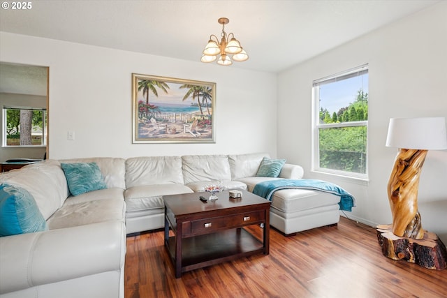 19030 SW Pike Ln, Beaverton, OR 97078 - living room with a chandelier, wood finished floors, and baseboards