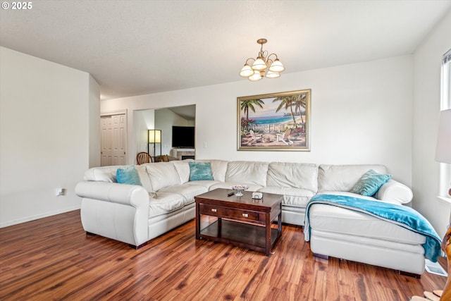 19030 SW Pike Ln, Beaverton, OR 97078 - living room featuring wood finished floors, a chandelier, and baseboards