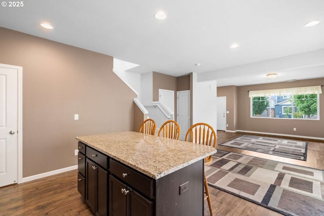 2344 SE 16th Aly, Gresham, OR 97080 - kitchen with a breakfast bar area, dark wood-type flooring, a kitchen island, open floor plan, and recessed lighting