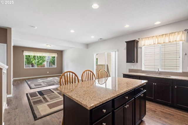2344 SE 16th Aly, Gresham, OR 97080 - kitchen with a kitchen island, wood finished floors, light stone counters, and recessed lighting