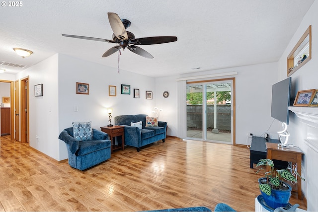2176 SE 63rd Ave, Hillsboro, OR 97123 - living room featuring light wood-style floors, a ceiling fan, and a textured ceiling