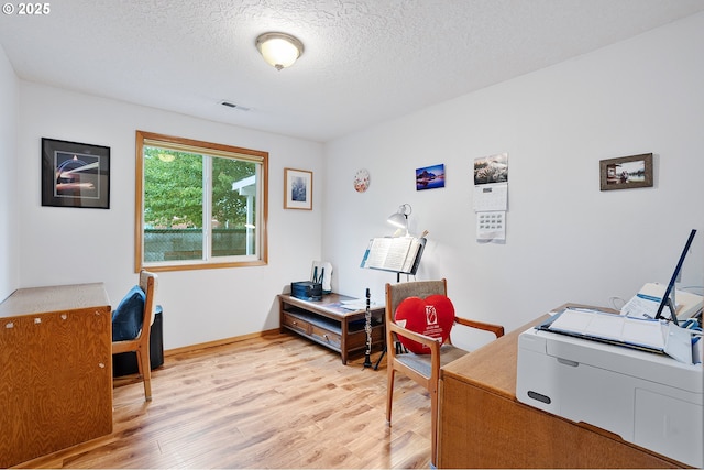 2176 SE 63rd Ave, Hillsboro, OR 97123 - office space with light wood-style floors, a textured ceiling, and baseboards