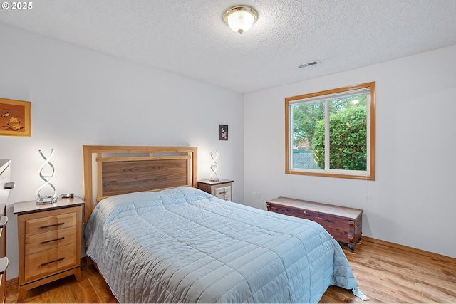 2176 SE 63rd Ave, Hillsboro, OR 97123 - bedroom featuring wood finished floors and a textured ceiling