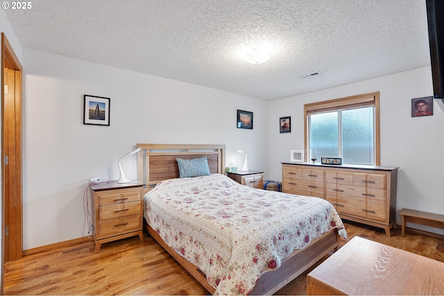 2176 SE 63rd Ave, Hillsboro, OR 97123 - bedroom featuring light wood finished floors, a textured ceiling, and baseboards