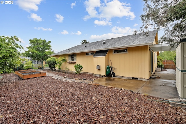 2176 SE 63rd Ave, Hillsboro, OR 97123 - back of property featuring a vegetable garden, a patio, and a shingled roof