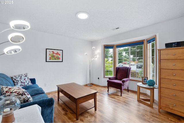 2176 SE 63rd Ave, Hillsboro, OR 97123 - living room featuring wood finished floors, baseboards, and a textured ceiling