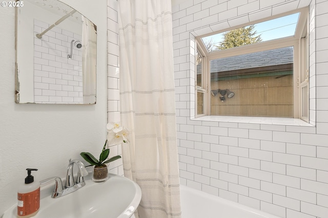 bathroom with sink and shower / bath combination with curtain