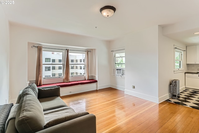 2566 NW Lovejoy St Unit 4, Portland, OR 97210 - living area with plenty of natural light, light wood-type flooring, and baseboards