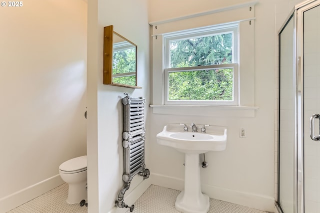 2566 NW Lovejoy St Unit 4, Portland, OR 97210 - bathroom featuring radiator, a shower stall, and tile patterned flooring