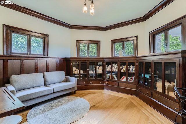 2566 NW Lovejoy St Unit 4, Portland, OR 97210 - living room featuring crown molding, healthy amount of natural light, and wood finished floors