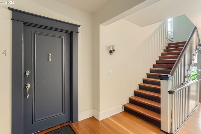 2566 NW Lovejoy St Unit 4, Portland, OR 97210 - entrance foyer featuring baseboards, light wood-type flooring, and stairs