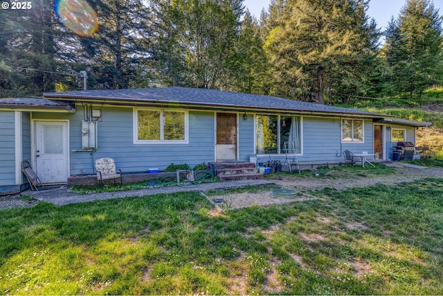 ranch-style house featuring entry steps and a front yard