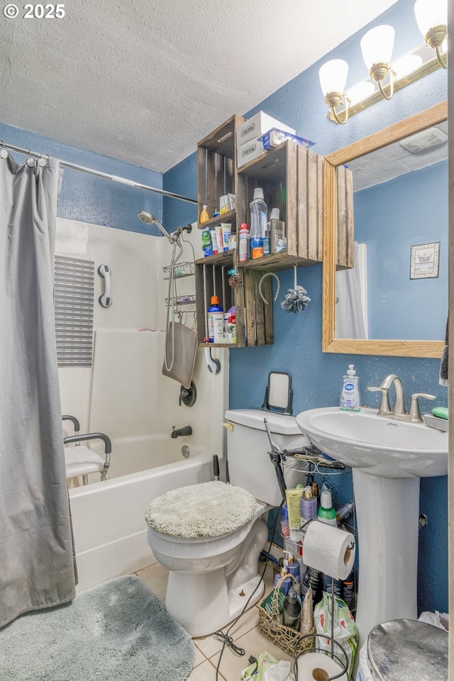 bathroom featuring tile patterned flooring, a textured ceiling, shower / tub combo, toilet, and a sink