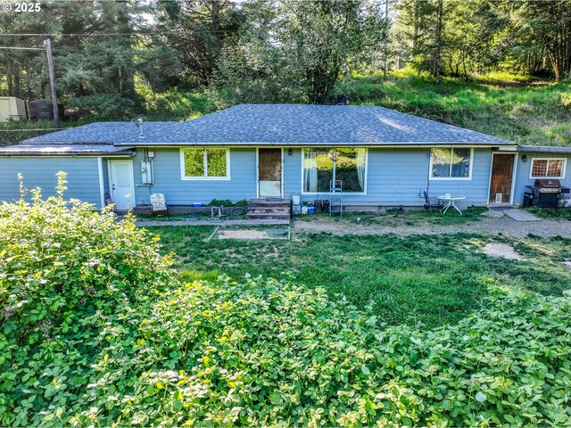 single story home with roof with shingles