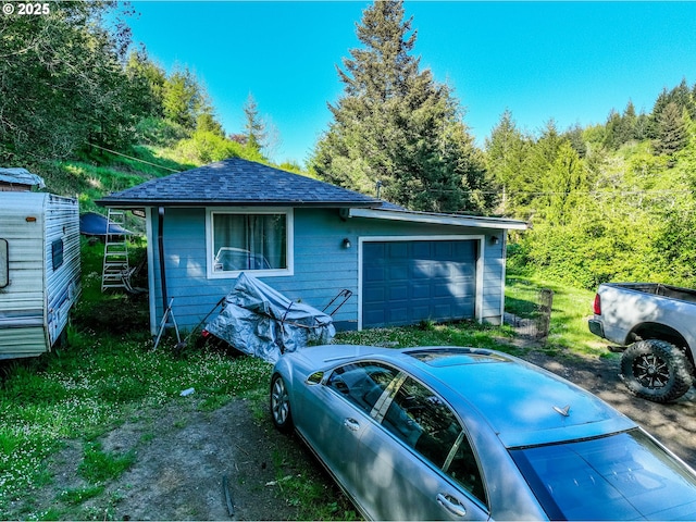 garage with a view of trees