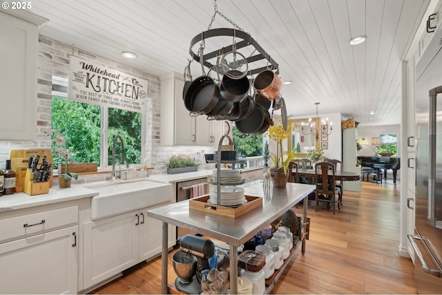 15785 SW Bull Mountain Rd, Portland, OR 97224 - kitchen featuring a sink, a chandelier, plenty of natural light, wood ceiling, and tasteful backsplash