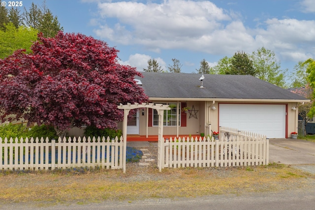 view of front of home featuring a garage, a fenced front yard, driveway, and a pergola
