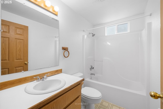 bathroom with toilet, vanity, and  shower combination