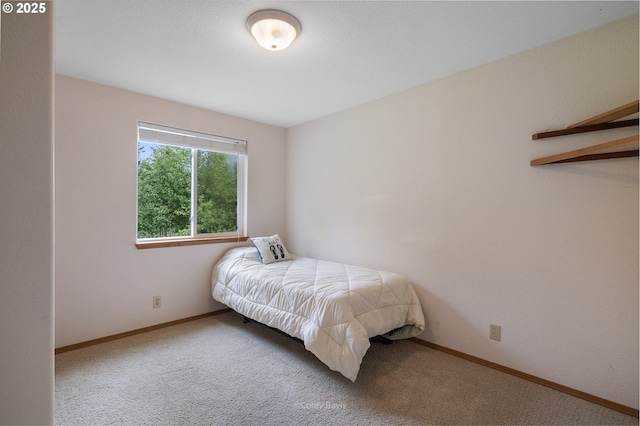 carpeted bedroom featuring baseboards