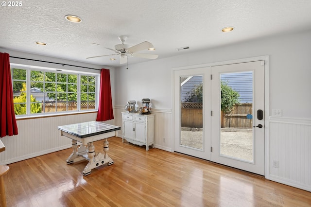 243 N 30th Ct, Cornelius, OR 97113 - dining room with a wainscoted wall, wood finished floors, a textured ceiling, and ceiling fan