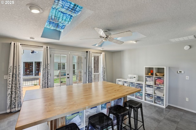 243 N 30th Ct, Cornelius, OR 97113 - dining room with french doors, a textured ceiling, ceiling fan, and dark tile patterned flooring