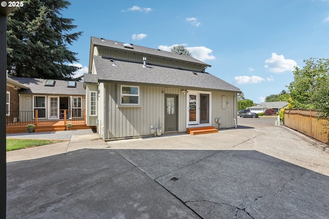 243 N 30th Ct, Cornelius, OR 97113 - back of house featuring a patio, a wooden deck, roof with shingles, and board and batten siding