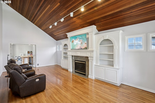243 N 30th Ct, Cornelius, OR 97113 - living area featuring rail lighting, wooden ceiling, wood finished floors, a high end fireplace, and built in features