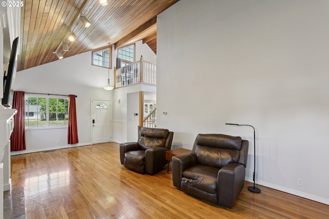 243 N 30th Ct, Cornelius, OR 97113 - sitting room with a wooden ceiling with exposed beams, track lighting, high vaulted ceiling, wood finished floors, and stairs
