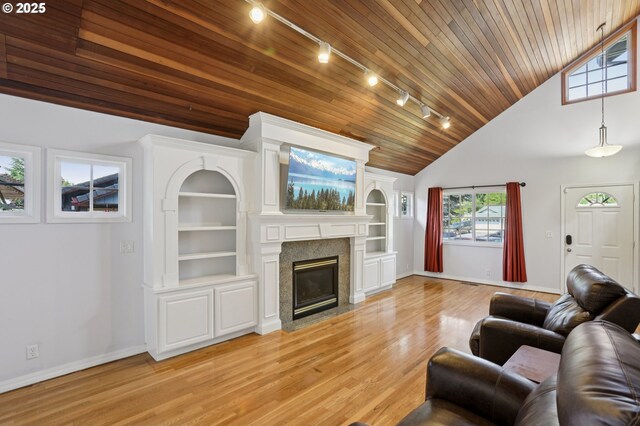243 N 30th Ct, Cornelius, OR 97113 - living area featuring wooden ceiling, rail lighting, a fireplace with flush hearth, light wood-style floors, and built in features