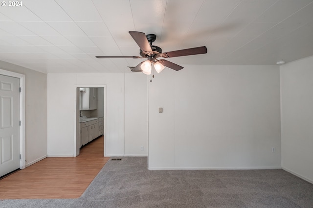 spare room featuring baseboards, a ceiling fan, and wood finished floors