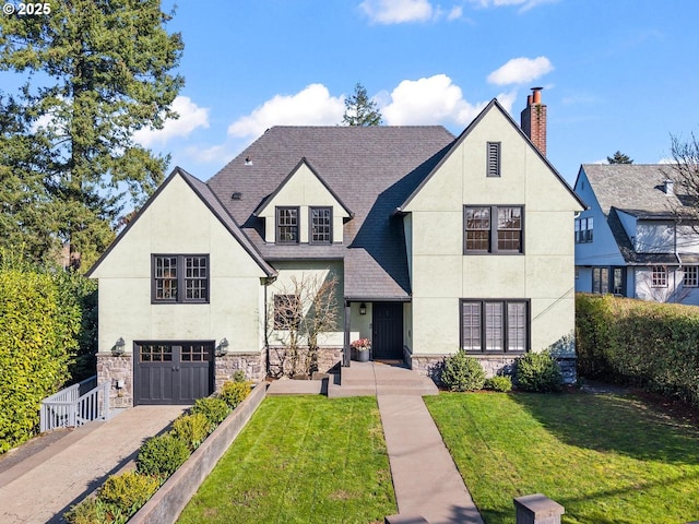 view of front of home featuring a front yard, a chimney, stucco siding, a garage, and stone siding