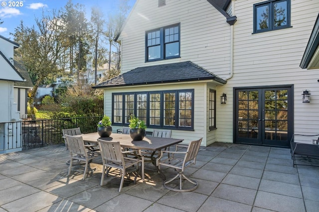 view of patio / terrace with outdoor dining space, french doors, and fence