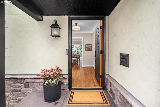 doorway to property featuring stucco siding