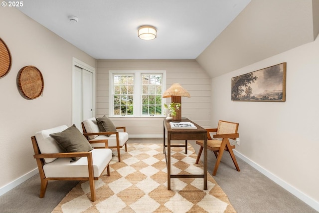 office area with vaulted ceiling, light colored carpet, and baseboards