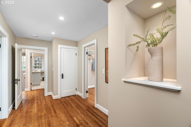 hall with recessed lighting, baseboards, and wood finished floors