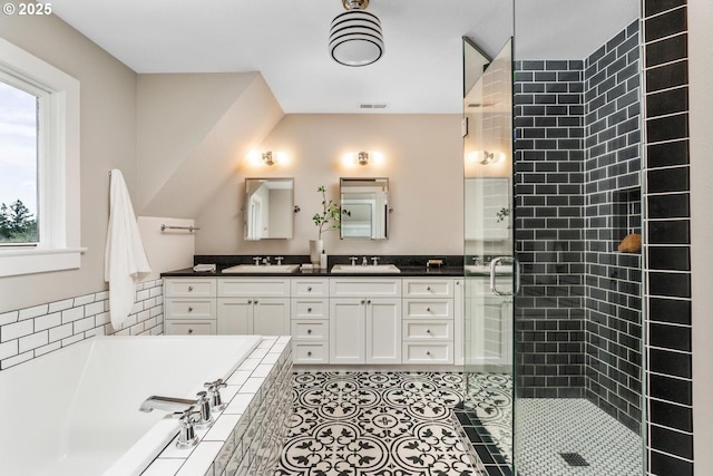 bathroom featuring visible vents, a garden tub, a sink, a shower stall, and double vanity