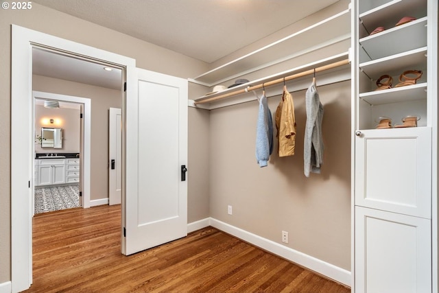 spacious closet with wood finished floors