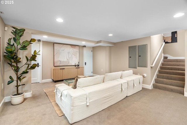 living room featuring recessed lighting, baseboards, light carpet, and stairs