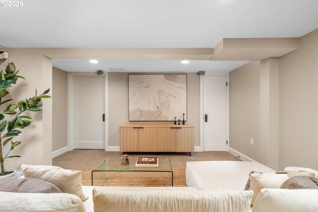 living room with recessed lighting, baseboards, and light carpet